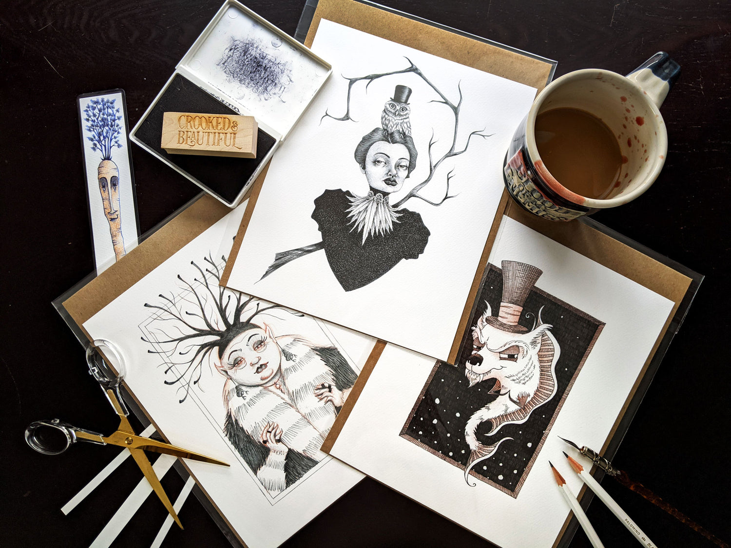 Collection of prints and office supplies on a desk surface